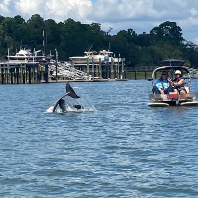 a group of people in a small boat in a body of water