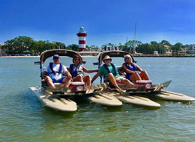 HHI_Dolphin_Cruise skiff sitting in front of harbor town light house on hilton head island